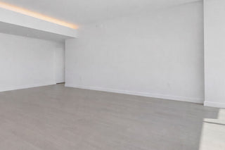 Luxury Home Staging Before-After -Empty room with white walls and a gray floor