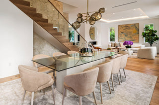 Luxury Home Staging Before-After -Modern dining room with glass table and beige chairs in a stylish home interior.