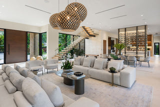 Luxury Home Staging Before-After -Modern living room with a large sectional sofa, coffee table, and decorative elements.