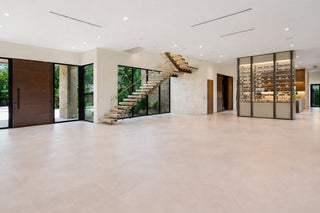 Luxury Home Staging Before-After -Modern interior of a house with a staircase and glass doors.