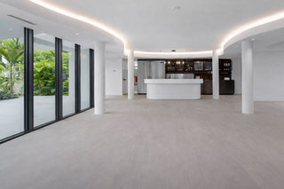 Luxury Home Staging Before-After - Modern interior of a building with a reception desk and glass walls.