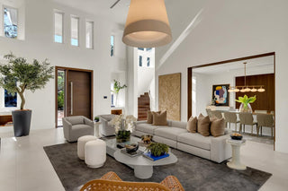 Turnkey Furniture Packages for purchase. Modern living room with white sofa, coffee table, and decorative items. All About the Wow