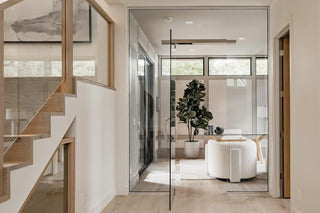 Turnkey Furniture Rental Miami. Modern interior with a staircase, glass door, and living room.