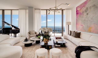 Luxury Home Staging in Miami - Modern living room with a grand piano, large windows, and a scenic view.